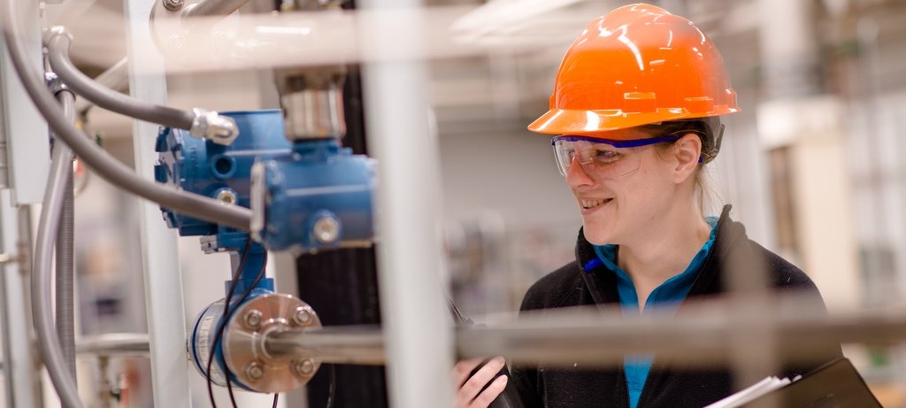 Student looking at equipment in a lab.