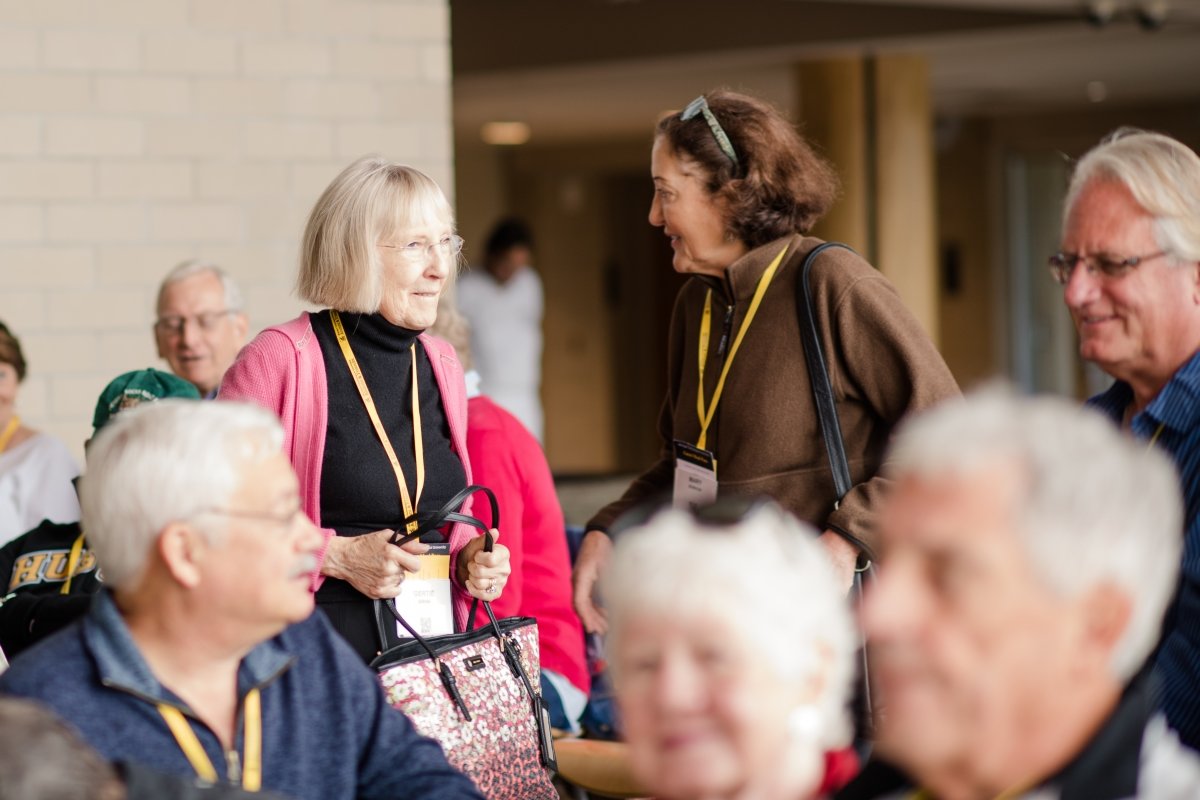 Alumni talking with each other at an event.