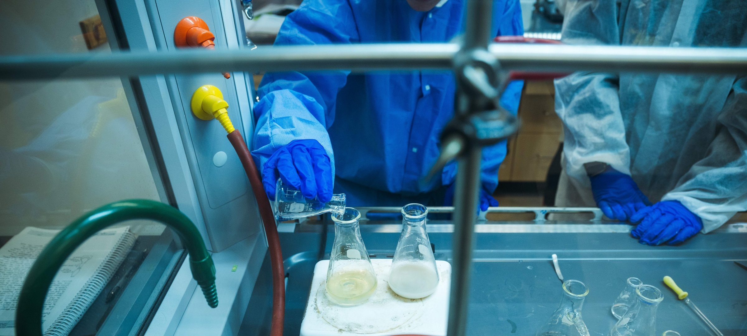 Hands pouring into beaker