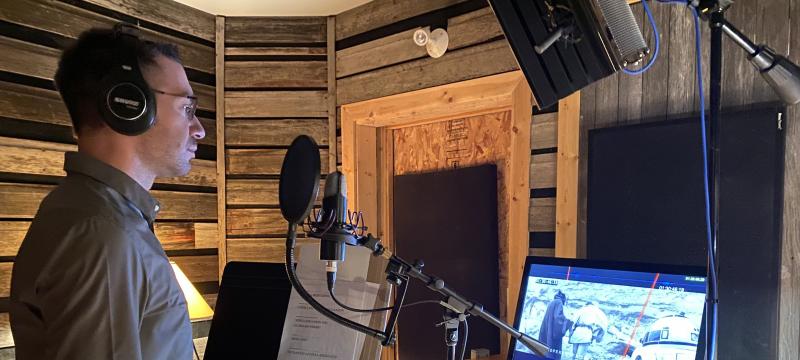 Tech alumnus Kalvin Hartwig â€™10 pictured in studio voicing his lines as Red Leader in Star Wars (Anangon Miigaading): A New Hope. (Image credit: Dr. Cary Miller)