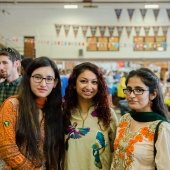 Three students pose for a picture at Parade of Nations. 