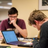 Student solving a Physics problem in the library.