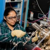 Graduate student working on equipment in the lab.