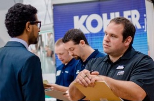 A recruiter listens to a student interviewee during Career Fair.