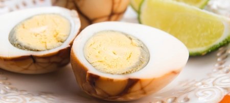 pickled eggs and limes on a plate