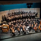 Orchestra and choir on stage.